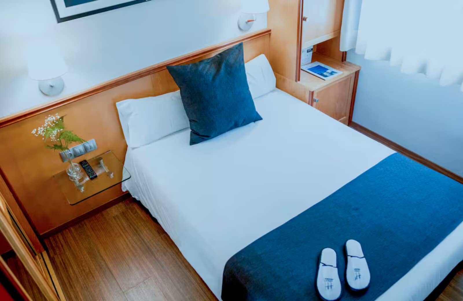 Guest bedroom with double bed and integrated headboard shelving