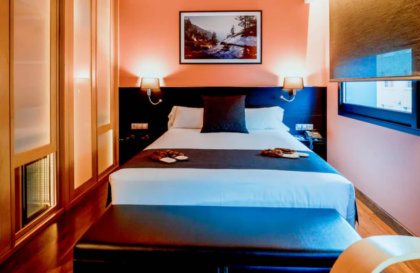 Guest bedroom with queen bed and floor-to-ceiling frosted glass wardrobes
