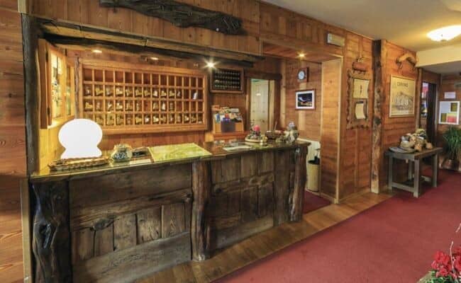 Lobby reception desk with rustic wood paneling and key cubbies