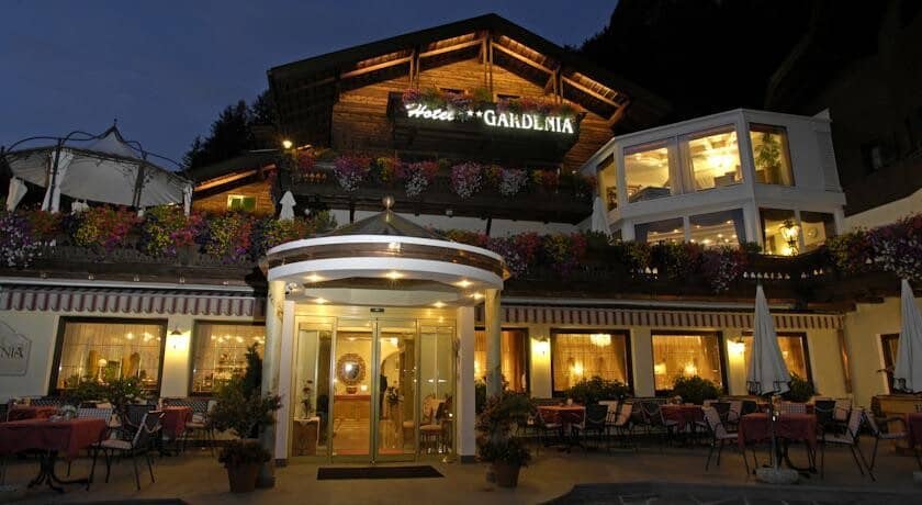 Hotel Gardenia exterior with evening patio seating and covered entrance