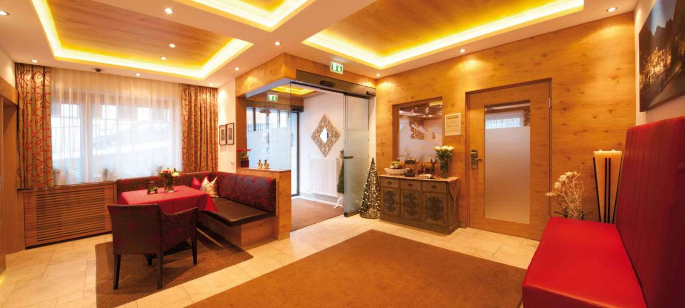 Lobby entrance with automated sliding doors and booth seating area