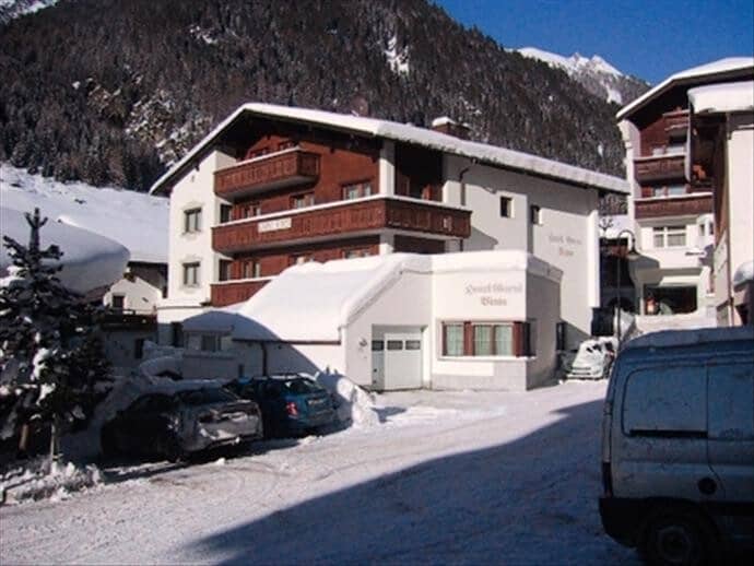 Chalet exterior with multiple private balconies and on-site parking