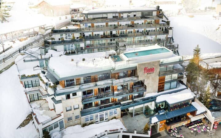 Ski-in/ski-out hotel exterior featuring a heated rooftop infinity pool