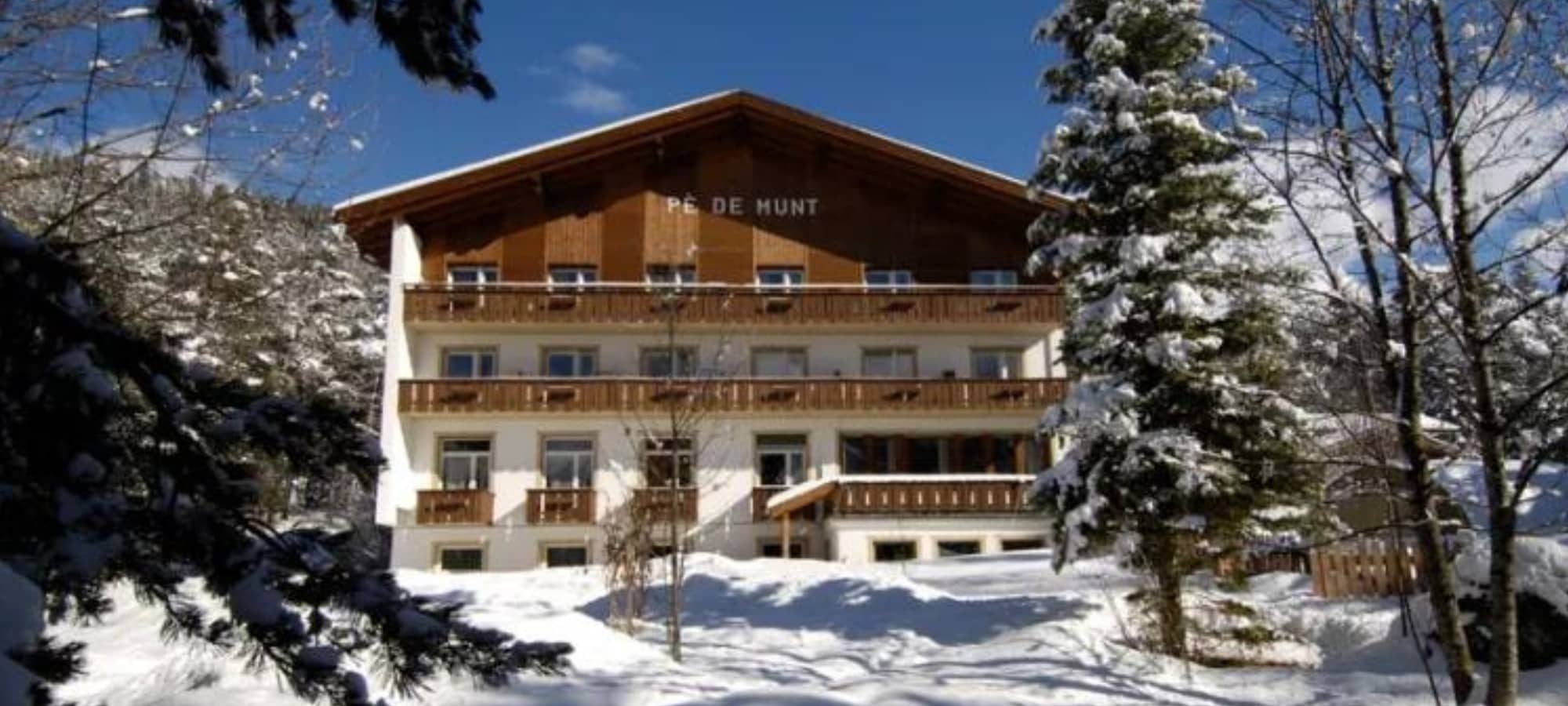Chalet exterior with multiple private balconies and direct snow access