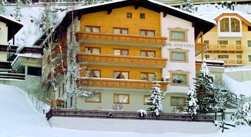 Chalet exterior featuring private balconies on all three upper levels