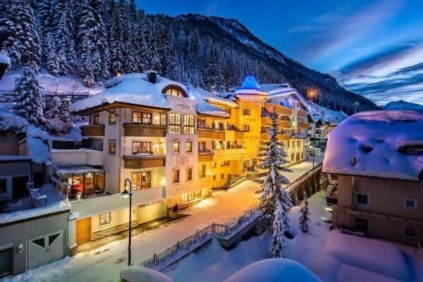 Ski-in lodge exterior featuring private balconies and immediate mountain access