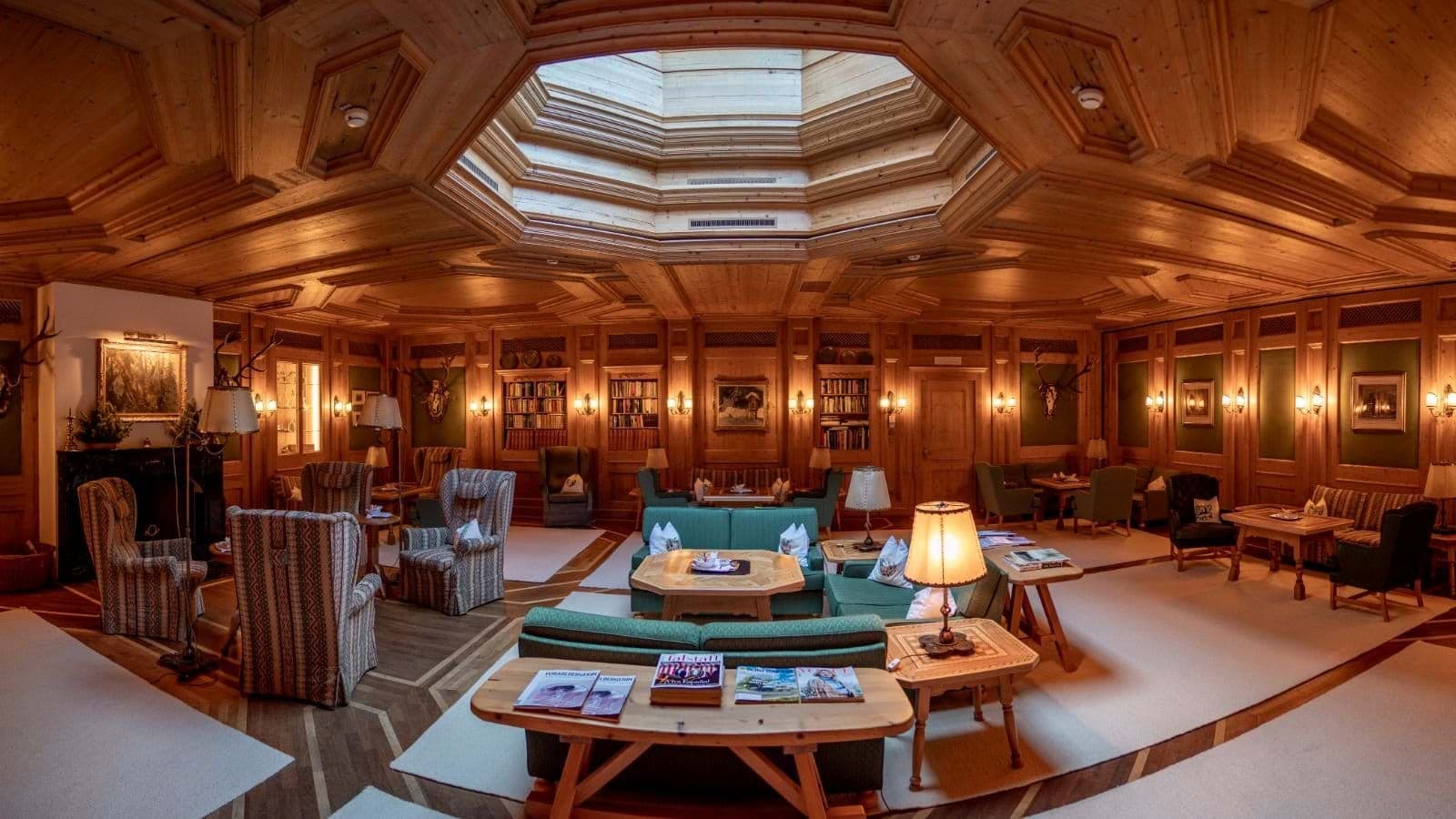 Wood-paneled lounge with octagonal skylight and built-in library shelving