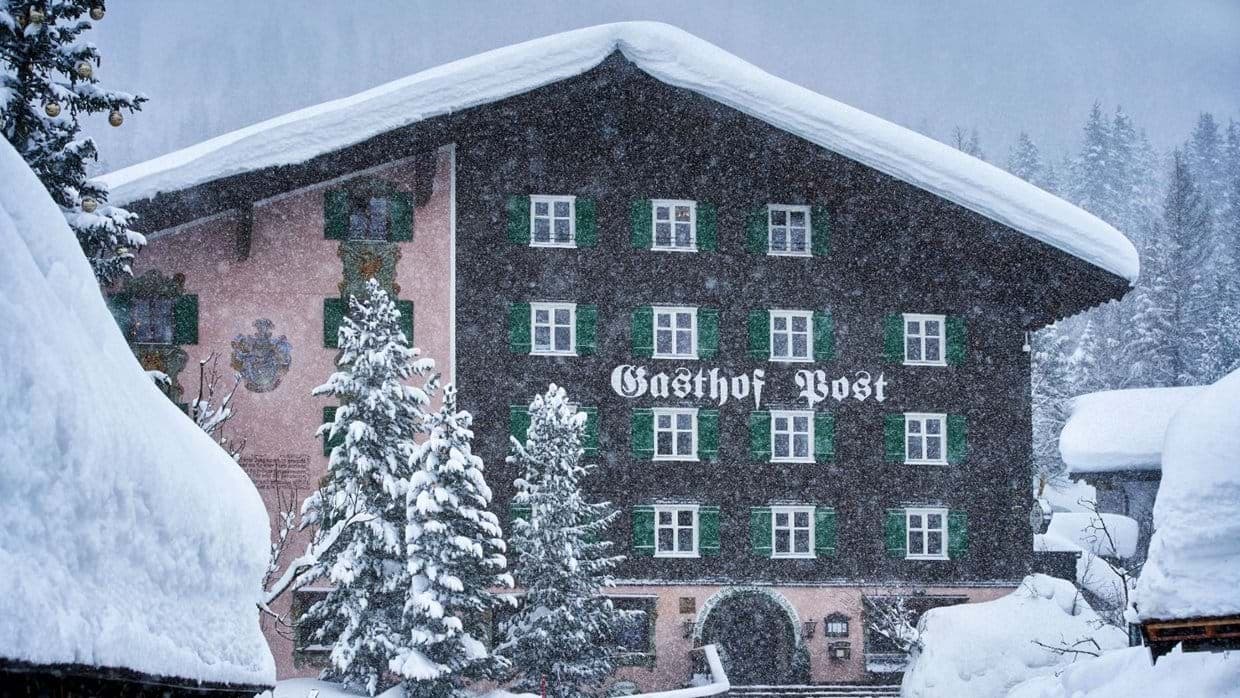 Traditional Austrian chalet exterior with original mural work and green shutters