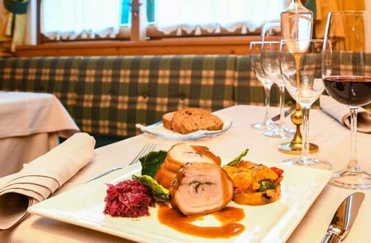 Dining area featuring upholstered plaid booth seating