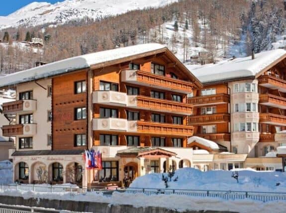 Ski-in chalet exterior with private balconies and mountain views