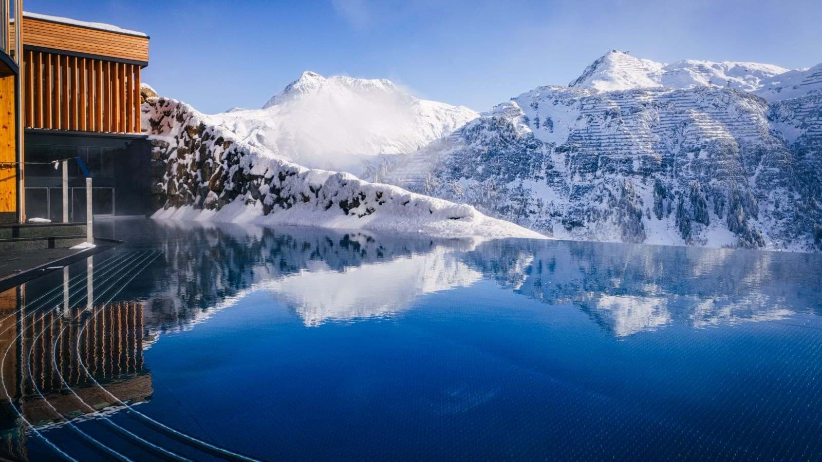 Heated infinity pool with panoramic Alpine mountain views