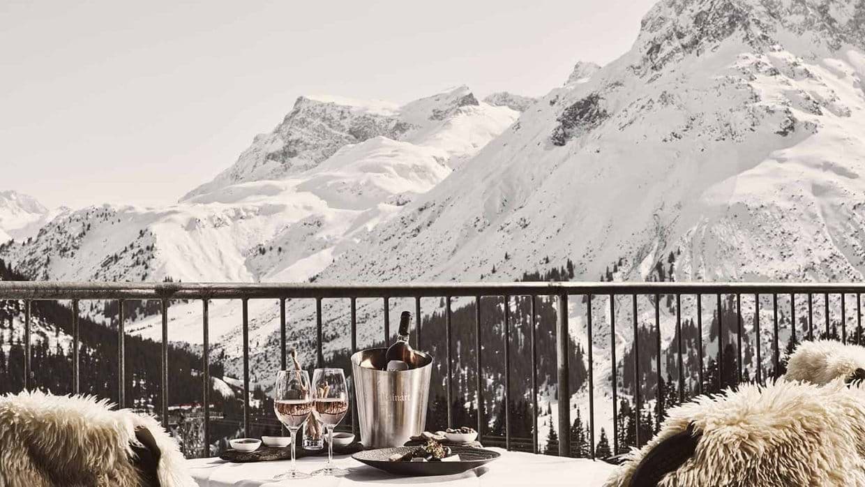 Private balcony with mountain views and sheepskin-covered seating