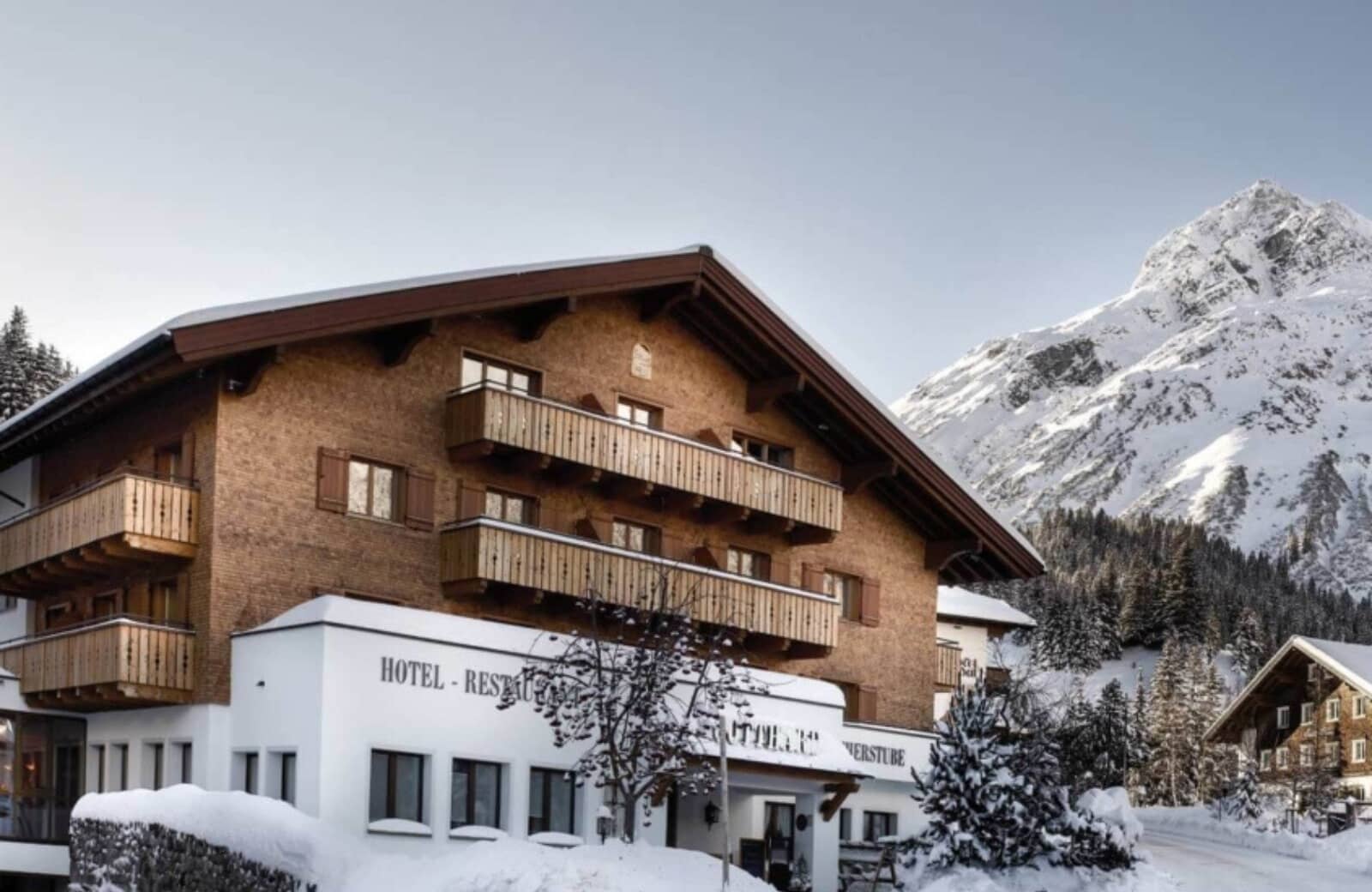 Chalet-style exterior with private balconies and mountain peak views
