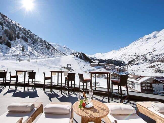 Private sun terrace with loungers and ski-in/ski-out mountain views