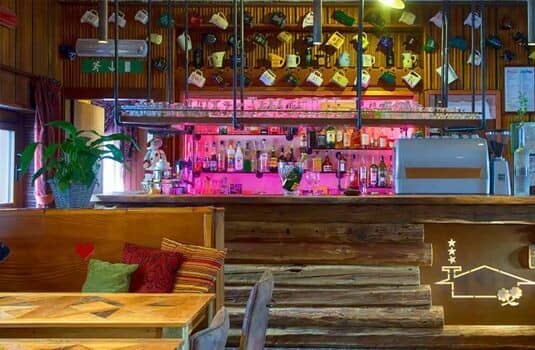 Indoor bar area with full spirit selection and espresso machine