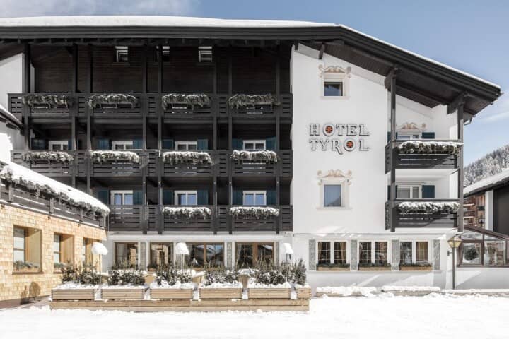 Hotel exterior with private balconies and snow-covered terrace seating