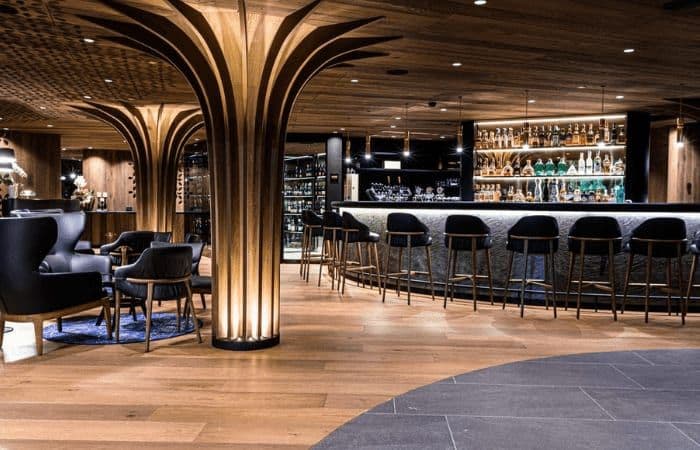 Bar and lounge area featuring wine cellar and seating for 10