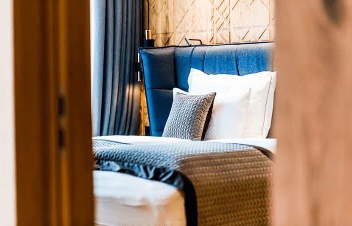 Guest bedroom with upholstered headboard and integrated reading lights
