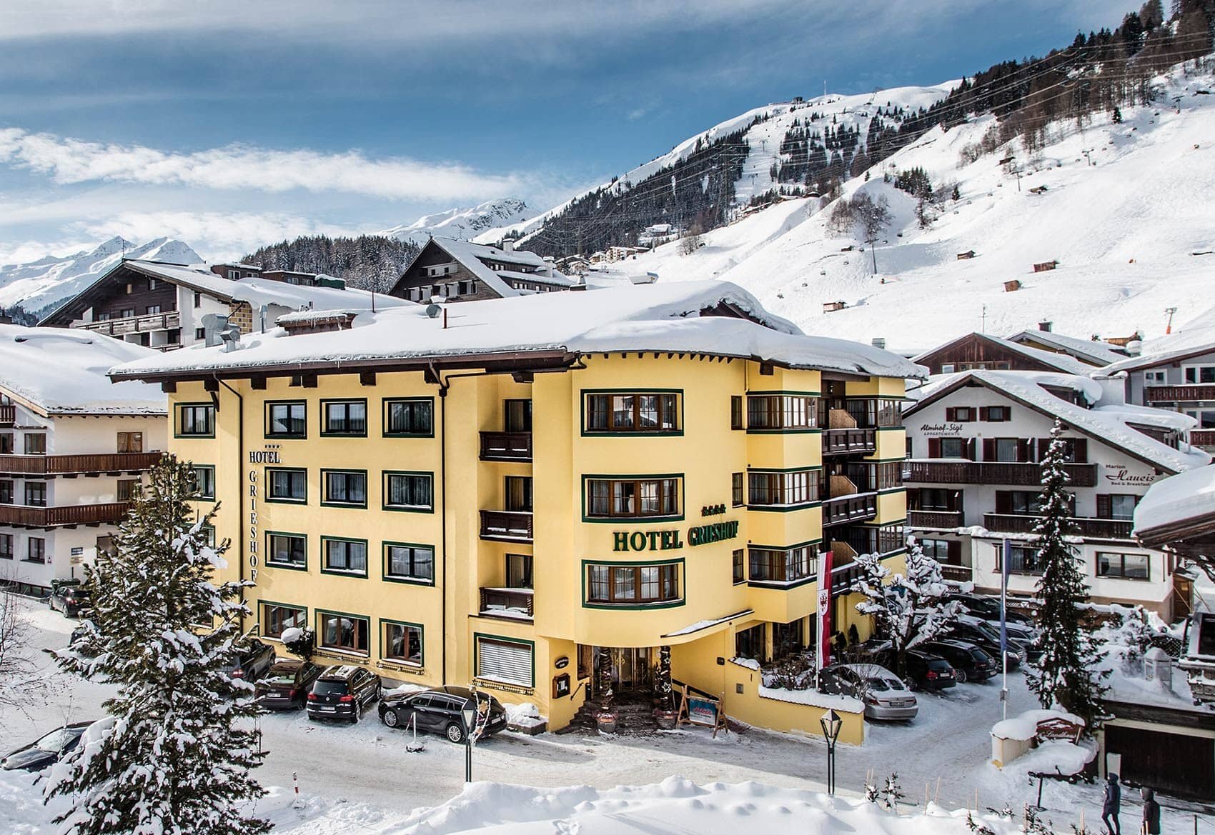 Hotel exterior with on-site parking and immediate access to ski slopes