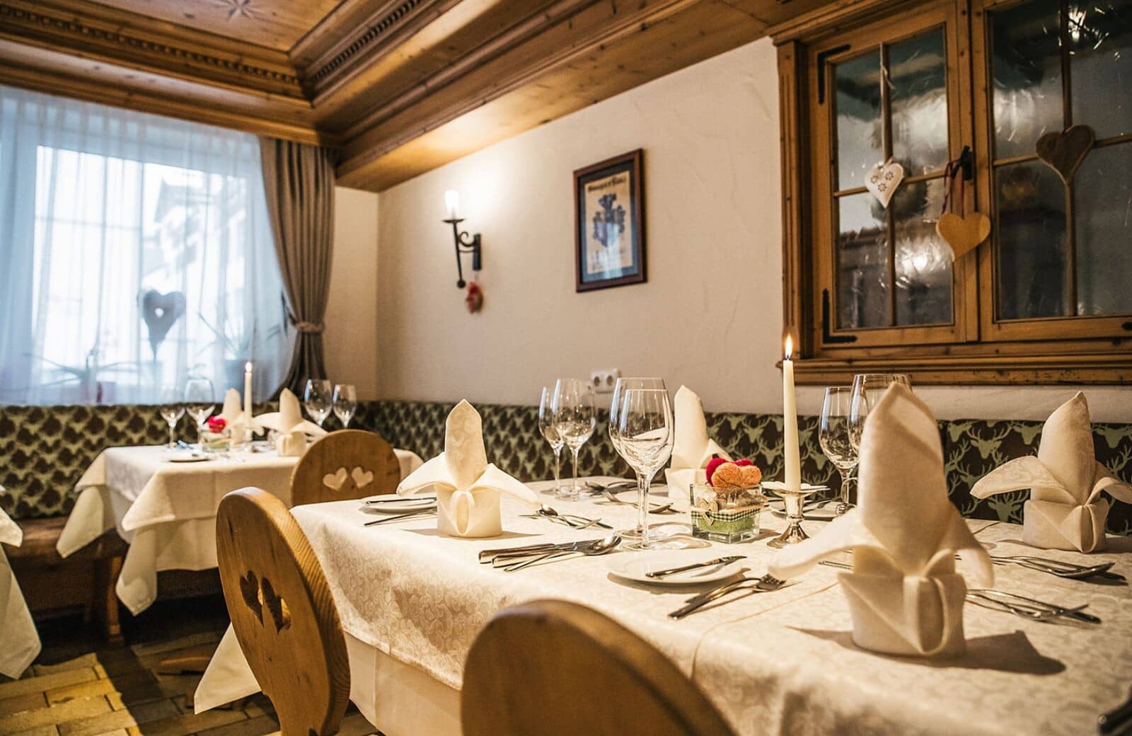 Dining area with banquette seating and traditional wood-paneled ceiling