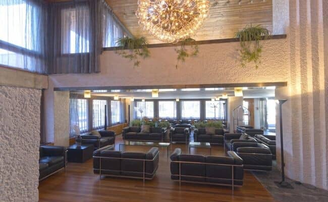 Shared lobby lounge with ample sofa seating and vaulted wood ceiling