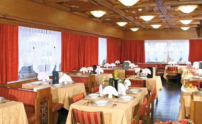 Dining hall with coffered wood ceiling and seating for 20+ guests