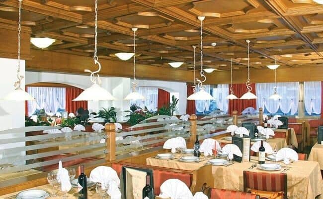 Dining room with coffered wood ceiling and seating for large groups