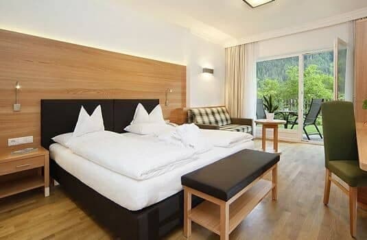 Guest bedroom with king bed and private balcony access