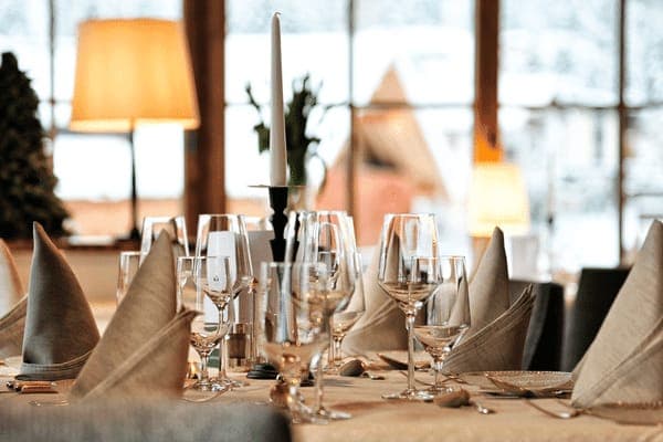 Dining table set for four with floor-to-ceiling mountain views