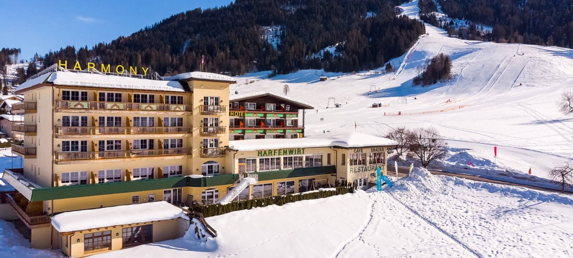 Ski-in/ski-out hotel exterior located directly at the base of groomed slopes
