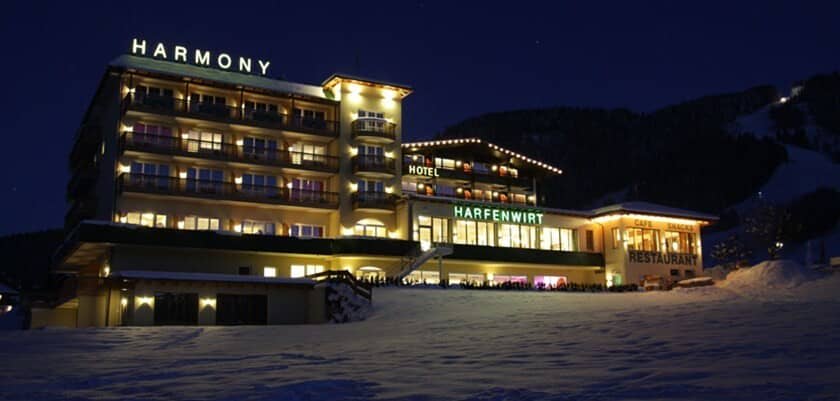 Hotel exterior at night with on-site restaurant and illuminated ski slopes nearby