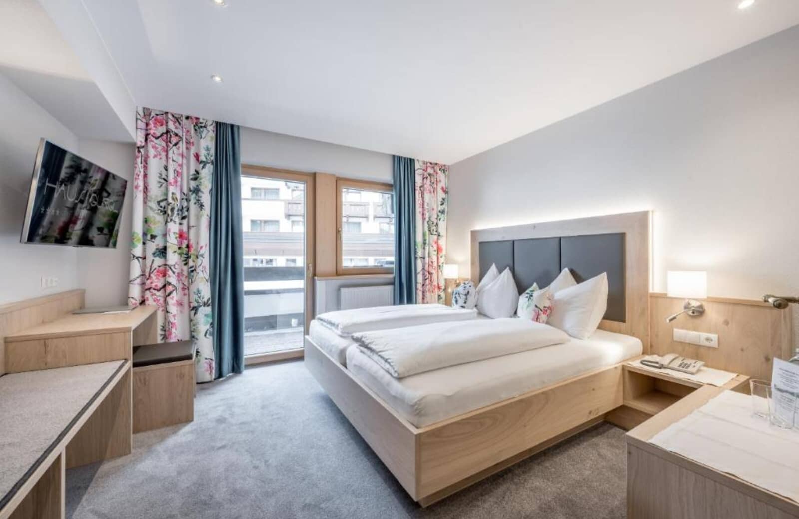 Guest bedroom with twin-to-king convertible bed and private balcony access