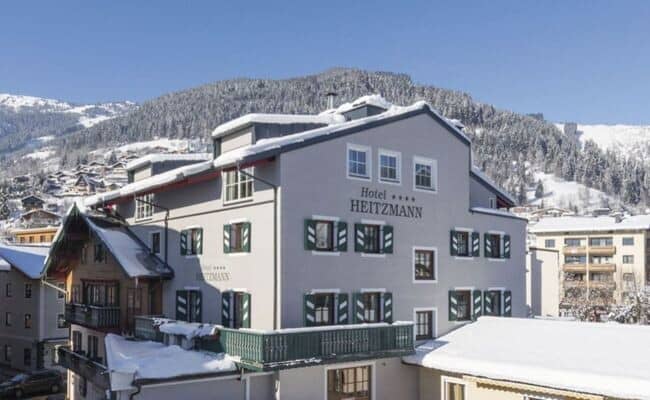 Hotel exterior with traditional shutters; located near alpine ski slopes