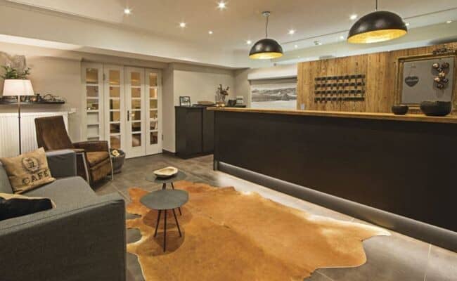 Reception desk with leather seating area and cowhide rug