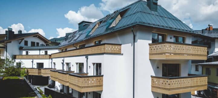 Building exterior with private wood-panelled balconies and metal roof