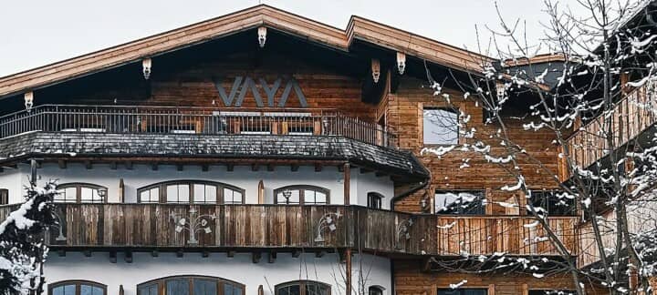 Chalet exterior featuring private timber balconies and snowy mountain setting