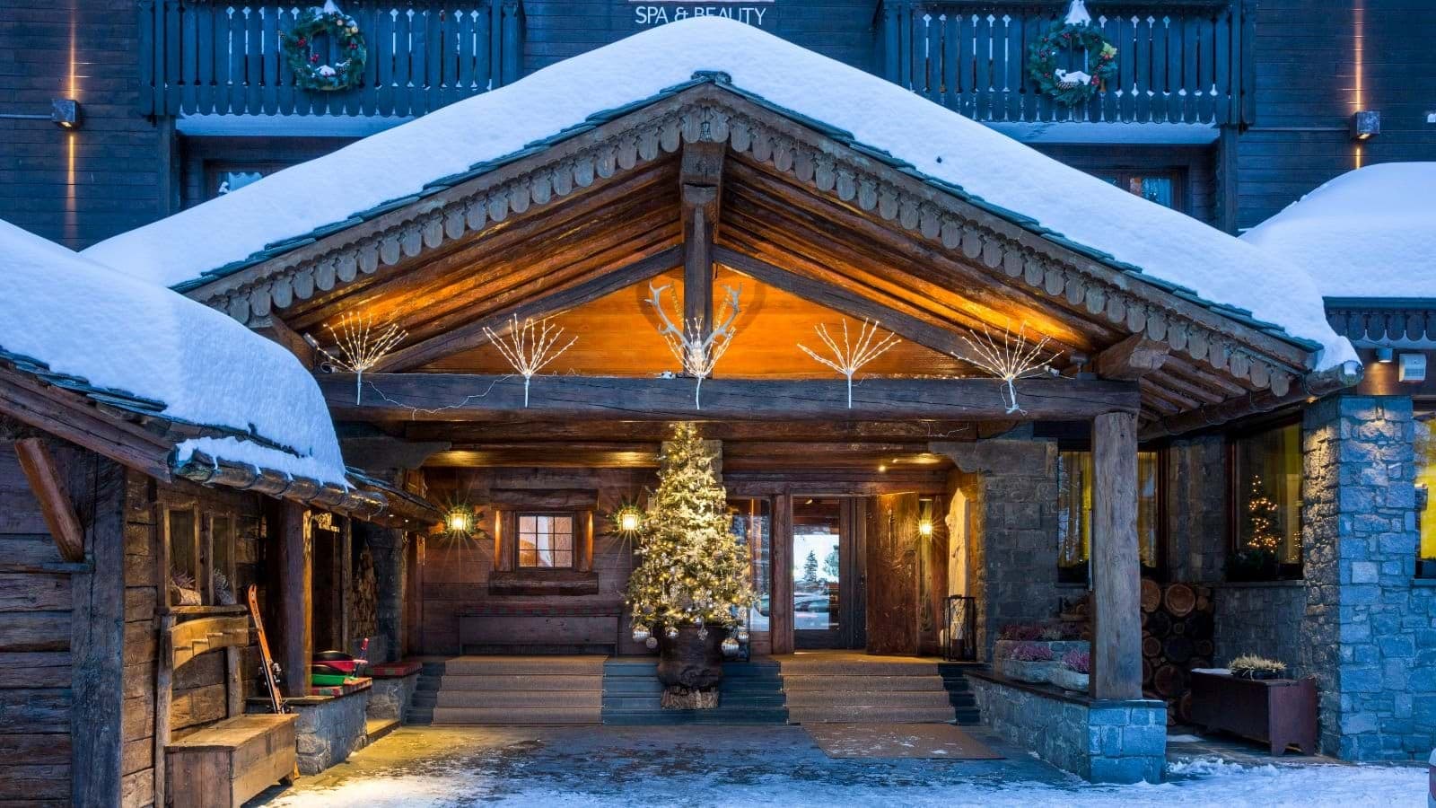 Main entrance with hand-carved timber beams and ski storage
