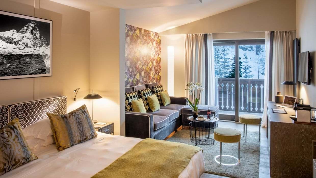 King bedroom with integrated sitting area and snow-view balcony