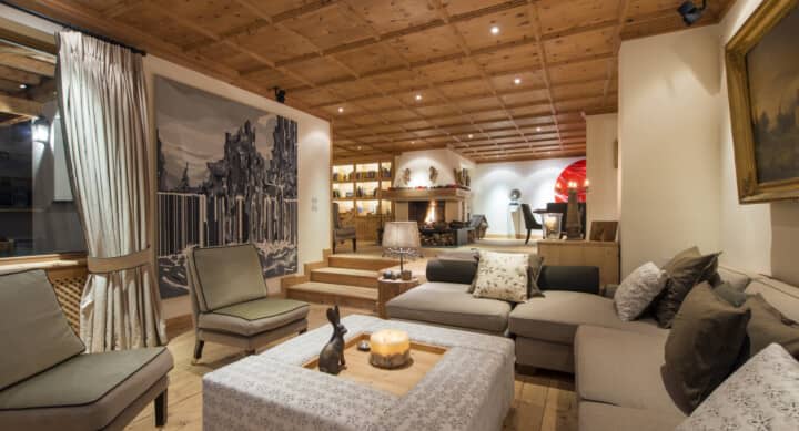 Sunken living room with wood-coffered ceiling and wood-burning fireplace