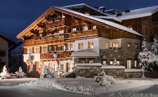 Ski-in/ski-out timber chalet with private balconies and stone exterior