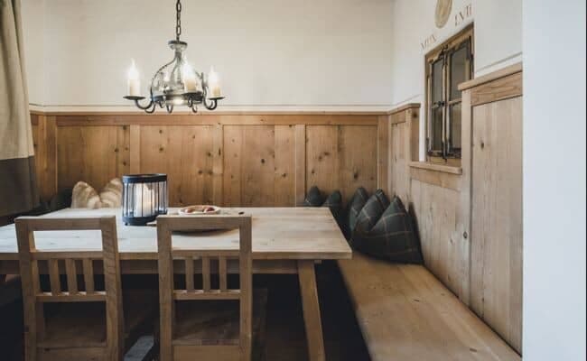 Dining area with wood paneling and corner banquet seating