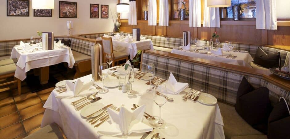 Dining area with booth seating and tables set for four
