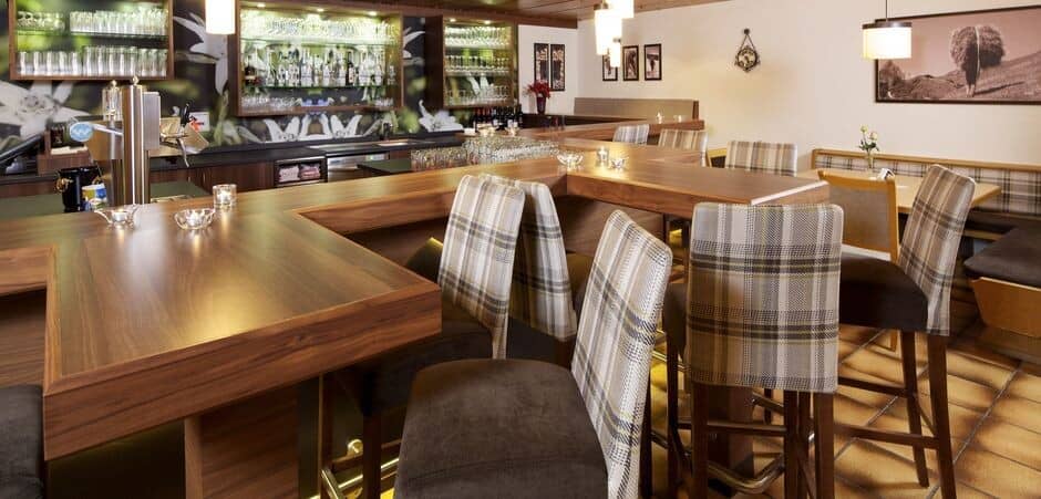 Commercial-style wet bar with beer tap and high-top seating for 10