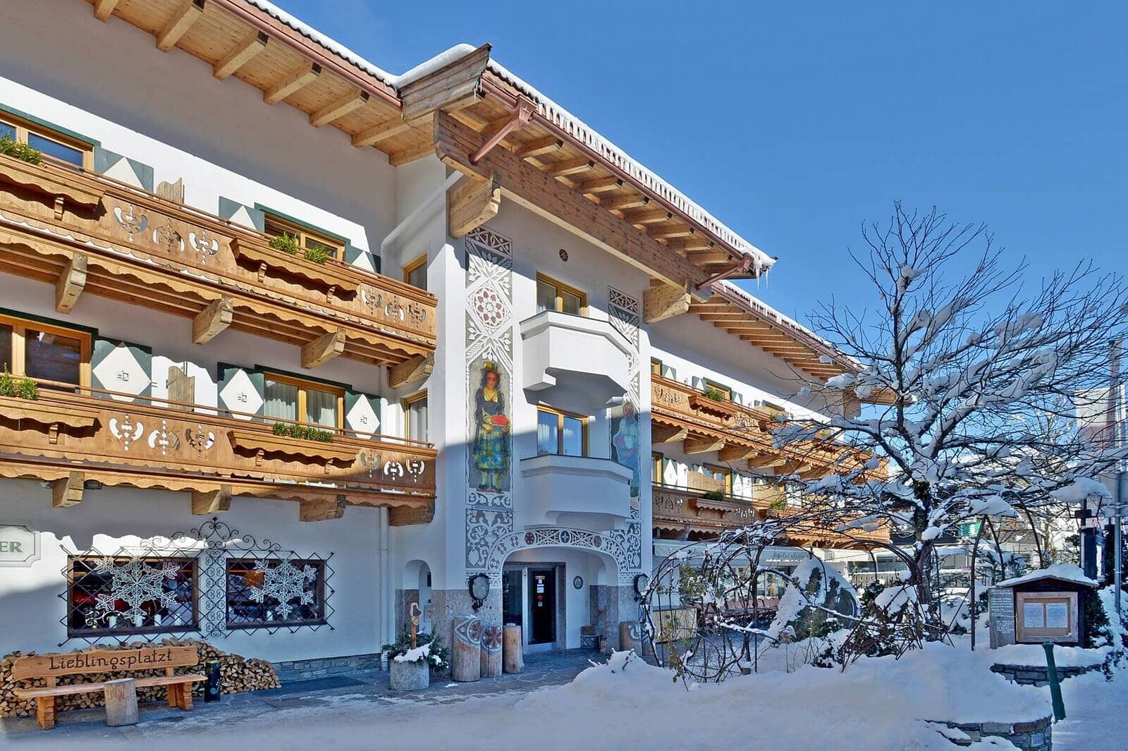 Alpine exterior with traditional painted murals and carved wooden balconies