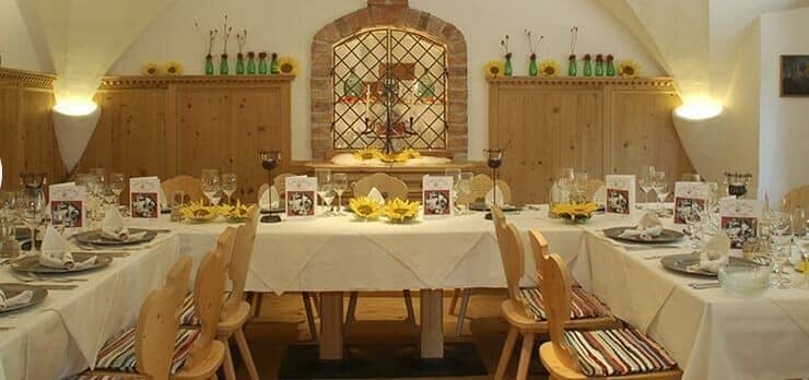 Vaulted dining hall with banquet seating for 14 guests