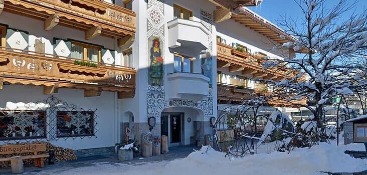 Chalet exterior with hand-painted frescoes and carved wood balconies