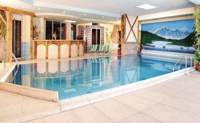 Indoor pool area with mountain mural and adjoining juice bar