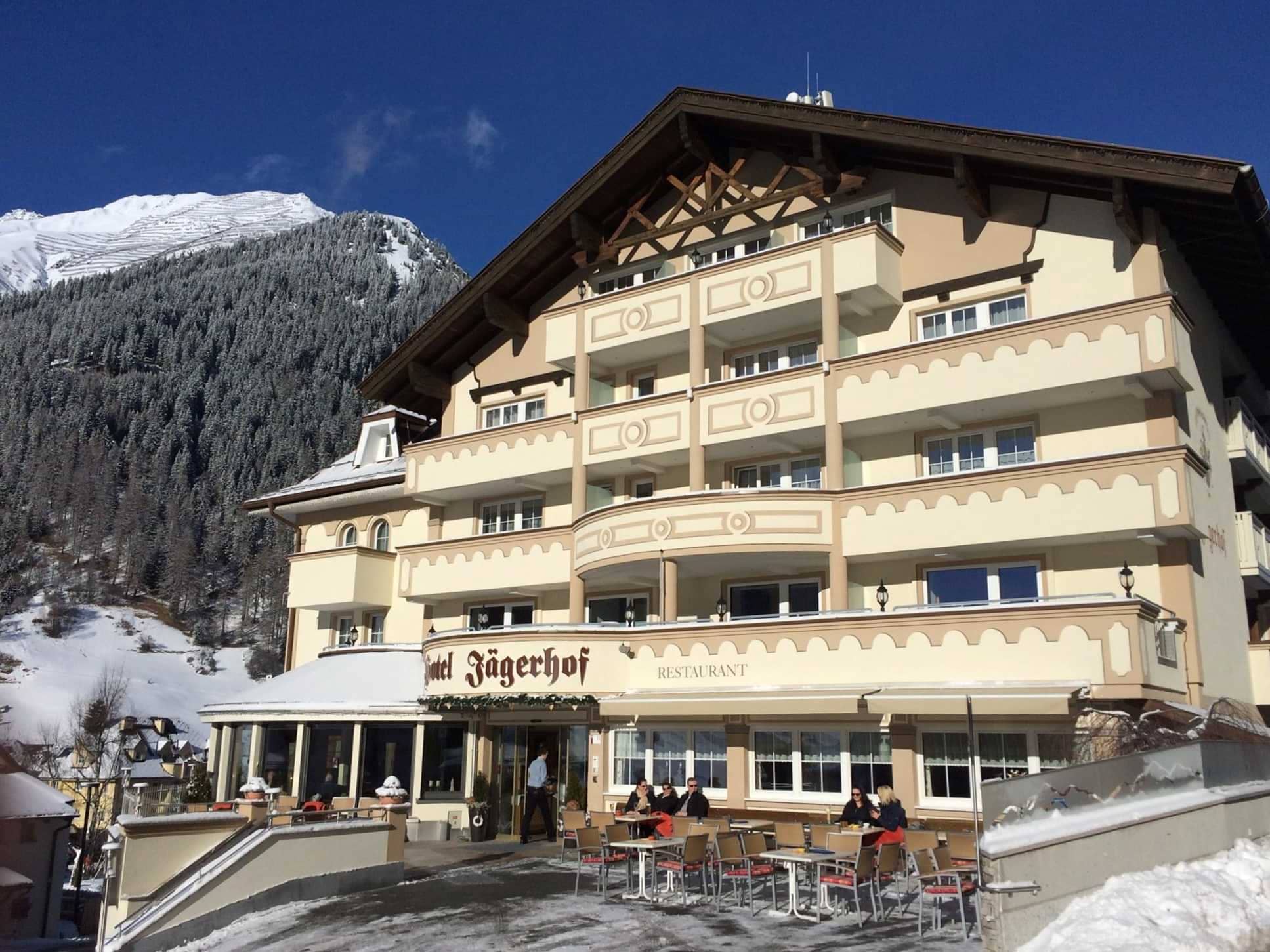 Hotel Jägerhof exterior with mountain views and outdoor restaurant terrace