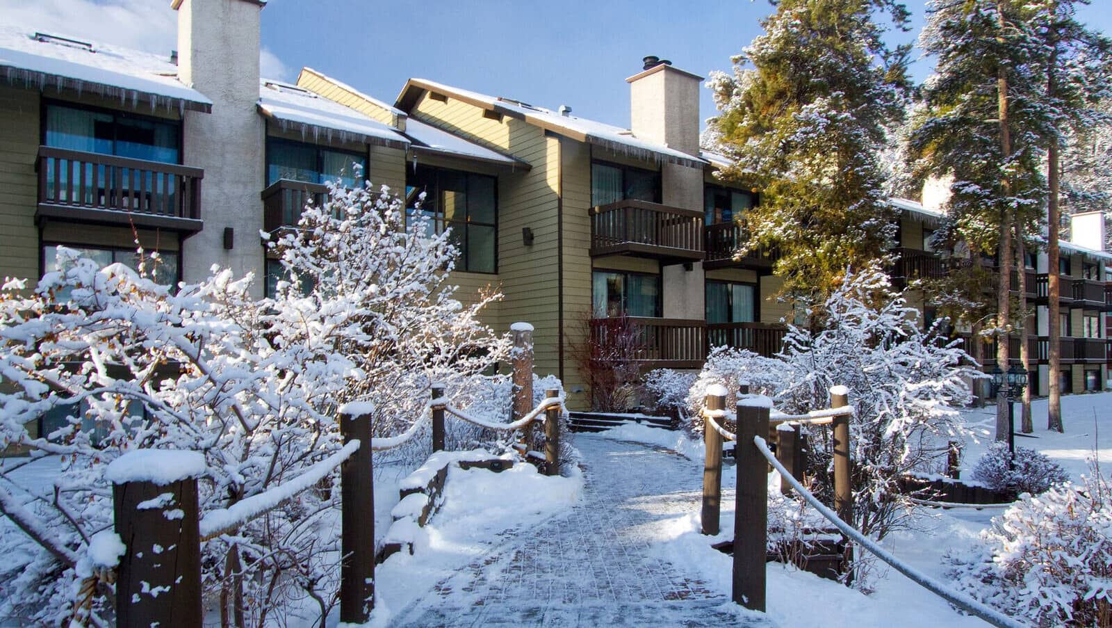 Condo exterior with private balconies and fireplaces for each unit