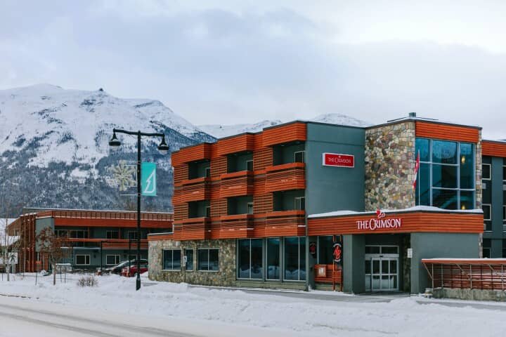 Crimson building exterior featuring private balconies and mountain views